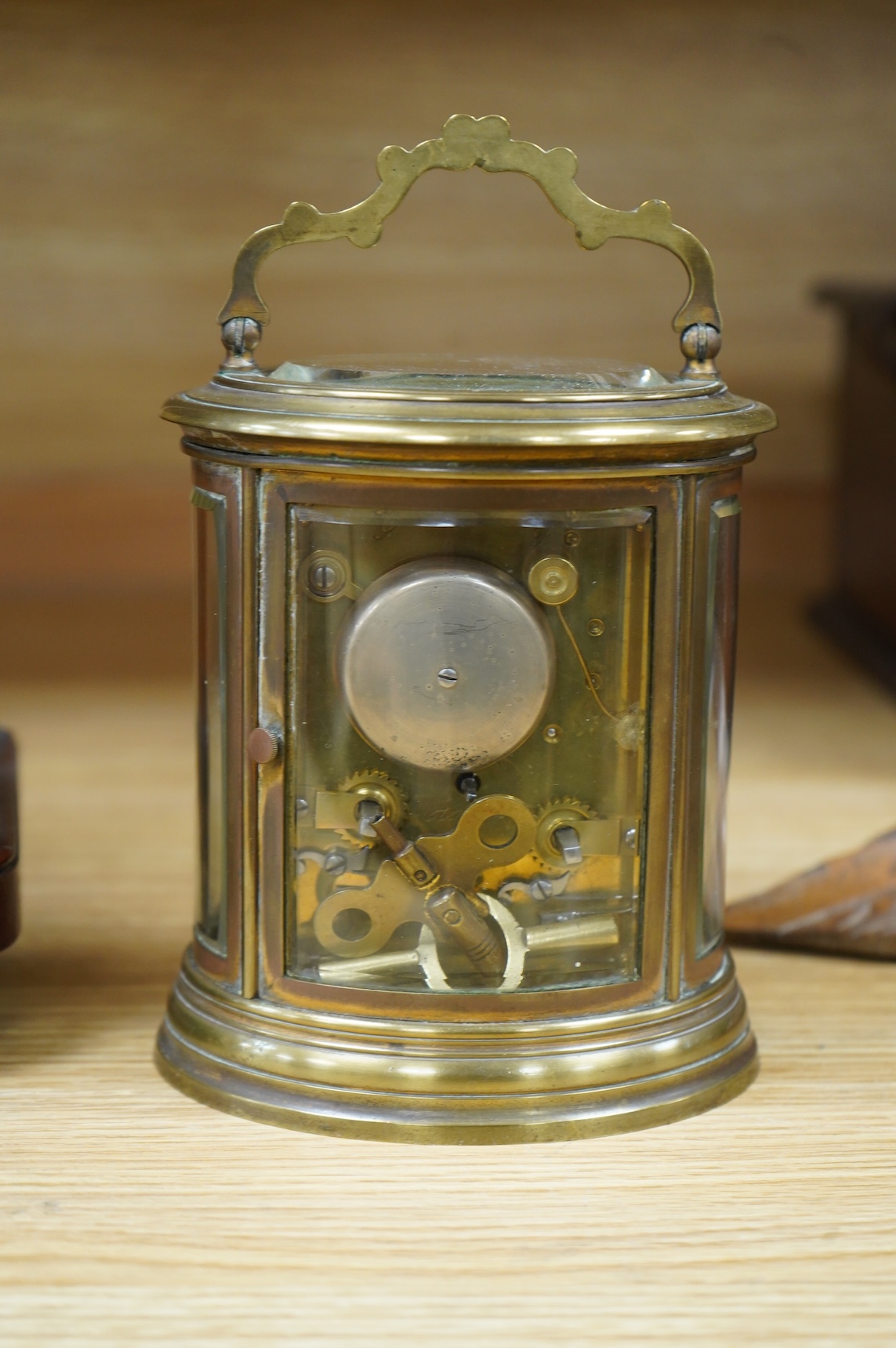 A 19th century oval brass carriage clock, striking on a bell, together with a mahogany and burr yew mantel clock, striking on a coiled gong, gong missing, largest 34cm high